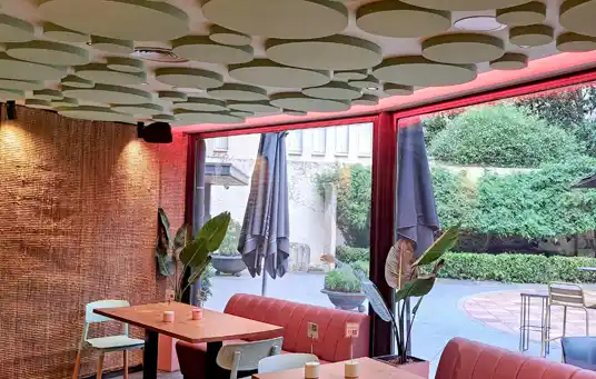 View of CHISME restaurant in Caldes de Montbui, Barcelona, after AICONNEX’s acoustic installation using eco-friendly sound-absorbing panels.