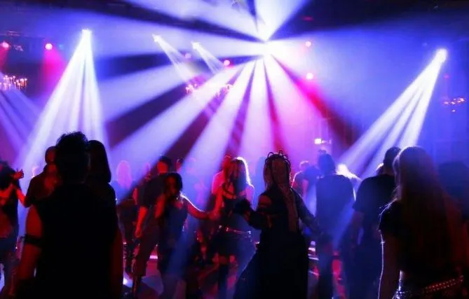 Lit dance hall with people dancing